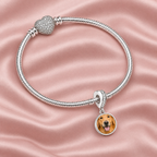 Personalized Custom Paw Photo Charm, on a charm bracelet laid on blush silk