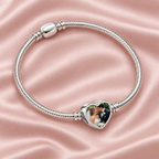 Personalized Custom Photo Charm, on a charm bracelet laid on blush silk