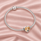 Personalized Custom Photo Dog Paw Charm, on a charm bracelet laid on blush silk